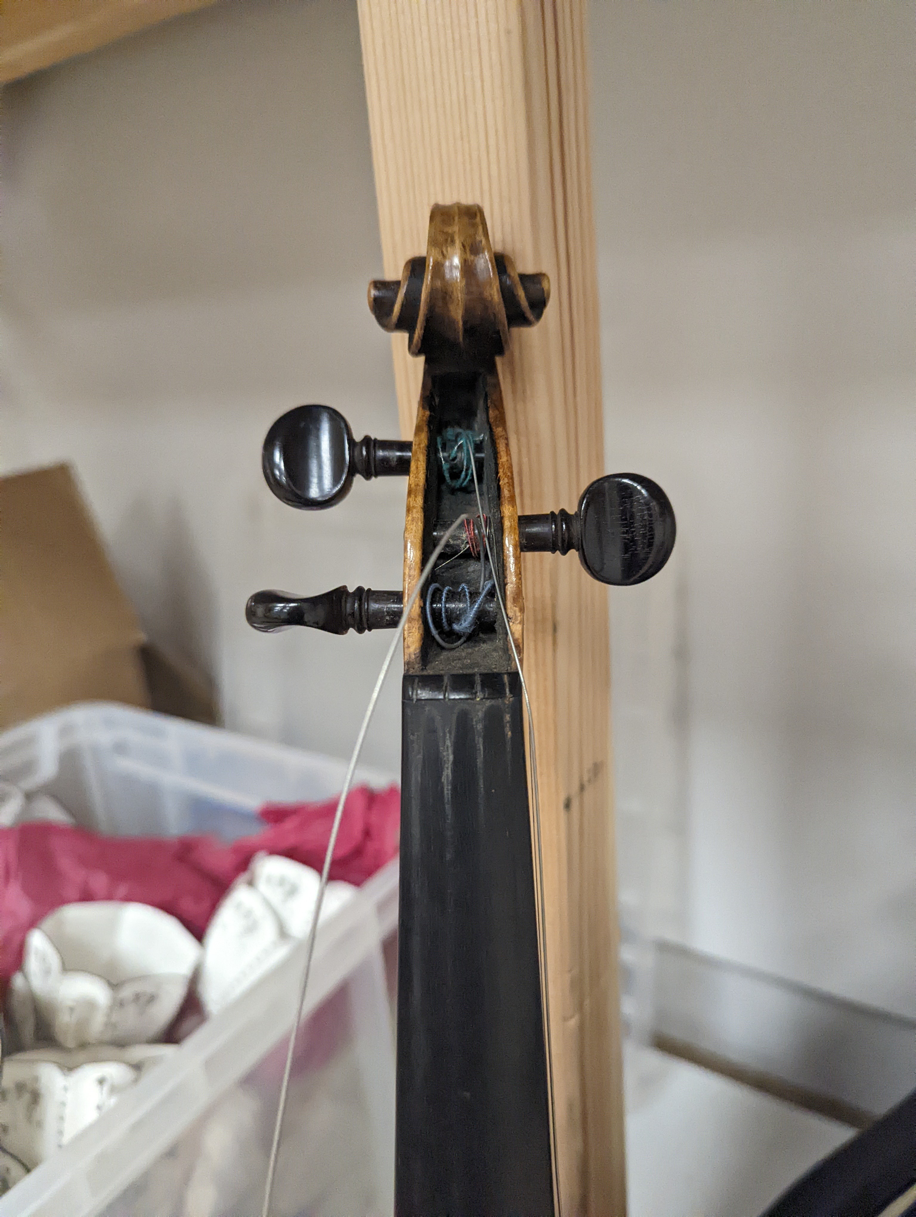 An early 20th century French or English violin with two bows, each stamped